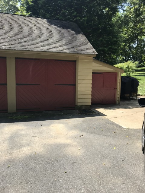Custom carriage-style barn doors with herringbone panel detail and black strap hardware
